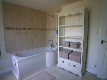 Full sized bath and shower at The Cornflowers Holiday Home